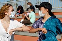 Teens elbow bump greeting in the new normal 