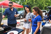 Friend grilling burgers at a tailgate party