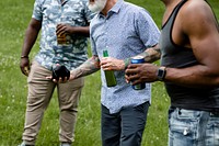 Friends playing cornhole at a summer party in the park