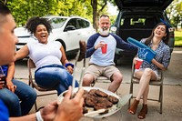 Friends drinking and eating at a tailgate party