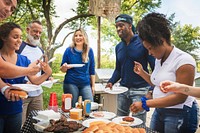 Friends drinking and eating at a tailgate party