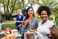 Friends celebrating and eating at a tailgate party