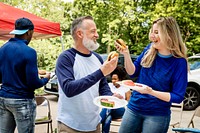 Friends drinking and eating at a tailgate party