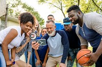 Basketball supporters watching their team win the game on a mobile phone