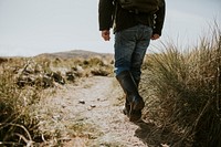 Camper walking through the beach side trail in Wales