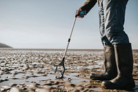 Beach cleanup volunteers picking up trash for environment campaign