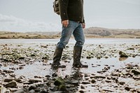 Tourist walking on the beach in Wales, UK