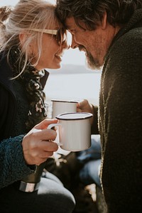 Camping couple having coffee in the morning