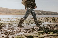 Tourist walking on the beach in Wales, UK