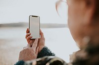 Senior woman using smartphone digital device screen with design space