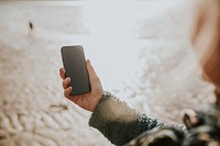 Senior woman using smartphone digital device screen with design space