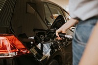 Woman filling petrol at a gas station