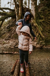 Family camping trip mother and daughter walking in the forest