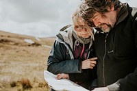 Senior tourist couple looking at the map while being lost in Wales, UK