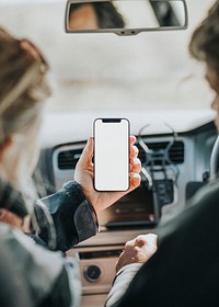 Senior tourist woman holding her smartphone with design space