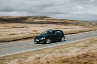 A black car driving on the highway in Wales, UK