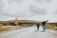 Happy senior tourist couple on the highway in Wales, UK