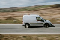 A gray van driving on the highway in Wales, UK