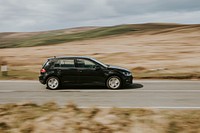 A black car driving on the highway in Wales, UK