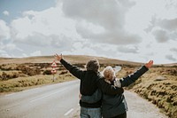 Happy senior tourist couple on the highway sideroad of Wales, UK