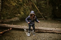 Family camping trip little girl playing by the lake in the forest