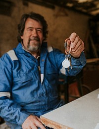 Senior small business owner holding his workshop’s keys