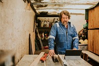 Senior carpenter working in his wood workshop