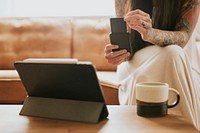 Woman using cashless payment card reader for her small business at home 