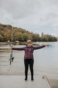 Happy retired senior woman on a fishing trip