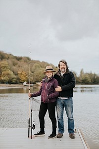 Retired senior couple posing on a fishing pier