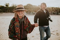 Retired senior couple enjoying holiday by the beach