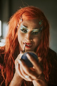 Drag queen applying lip liner, entertainment makeup look