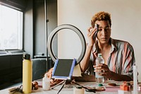 Non-binary person putting on makeup, beauty blogger