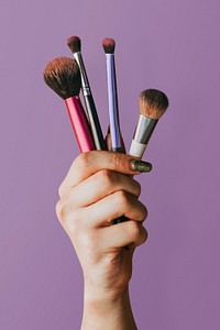 Hand psd holding makeup tools, beauty blogger