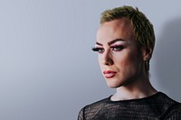 Blond non-binary person wearing makeup portrait