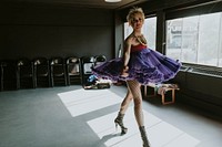 Happy drag queen in purple puffy dress