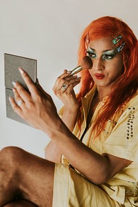 Drag queen applying blush, entertainment makeup