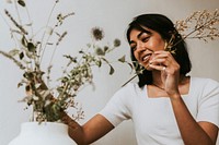 Florist arranging dried flowers, small business