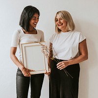 Women holding blank frame, design space