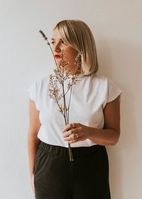 Sad blonde woman holding flowers