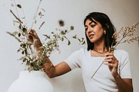 Florist arranging dried flowers, small business