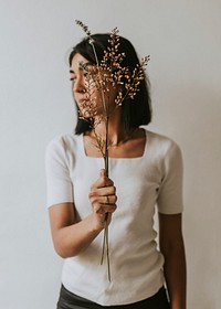 Sad woman holding flower, mental health