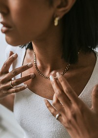 Gold necklace around woman's neck