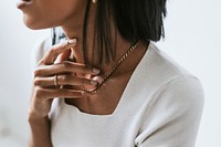 Woman touching her neck & gold necklace