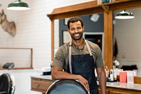 Cheerful hair stylist in barber shop