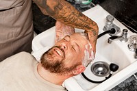 Man getting a hair wash at a barber shop