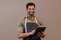 Man with apron using tablet psd, online booking system