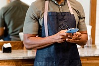 Barber texting in barber shop