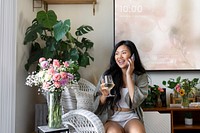 Woman on the phone, while drinking wine