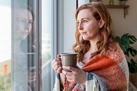 Sad lonely woman staring out the window